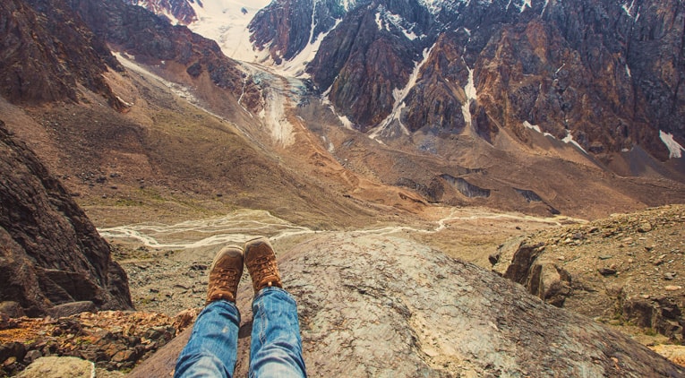 Person sitting on a mountain 