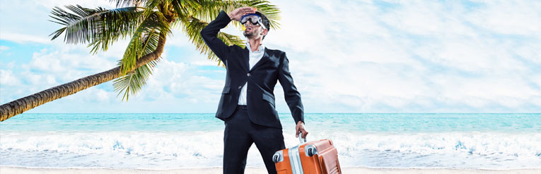 Man on beach with suitcase